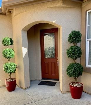 Artificial outdoor topiary trees in residential home