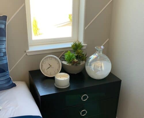 On a bedside table Succulent arrangements in bowl with white rocks