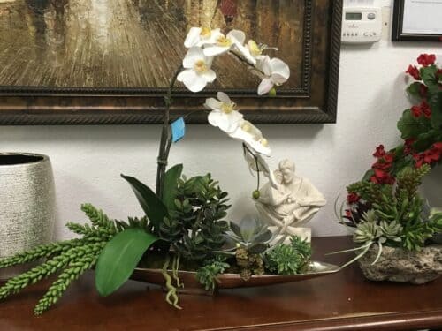 white orhids and succulents in boat Silk White orchids and succulents in boat